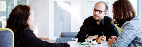 Meeting between two women and a man