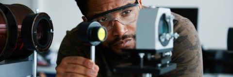 Male BAME scientist studying the Zeeman effect