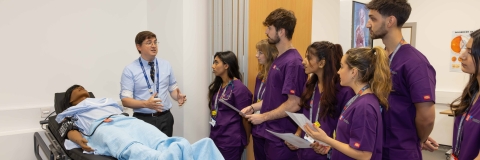 Medical Degree students watching a demonstration in mock hospital ward