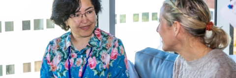 Two people sitting and talking