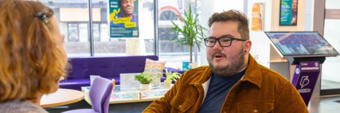 Two people sitting and talking