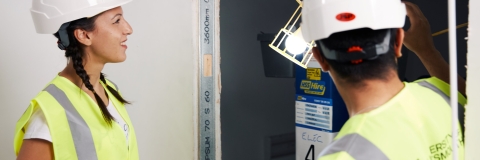 Female civil engineering student at building site