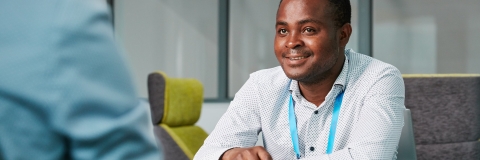 Two people sitting and talking