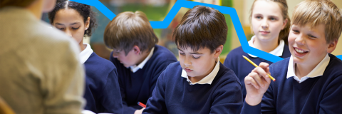 Five school pupils in a classroom