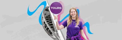 Female Student Ambassador with a tour paddle in front of Spinnaker Tower 