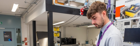 Male lecturer in the engineering lab using equipment