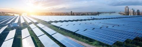 solar panel farm on the outskirts of large modern city