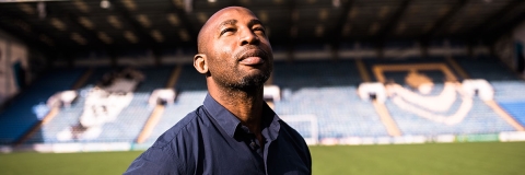 person stood in a football stadium, looking up