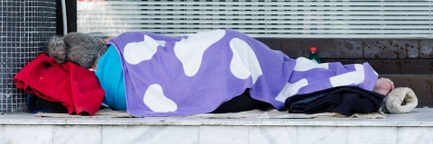 A person sleeping in a doorway