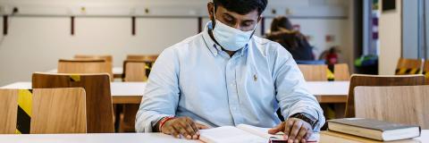 Man in mask reading under COVID-19 lockdown