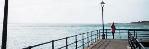 a female student from Mexico standing on a pier