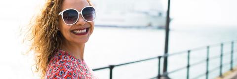 student smiling in the sun on Southsea pier