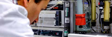 a male student from Oman using lab equipment