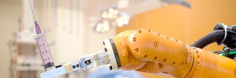 robot arm holding a syringe