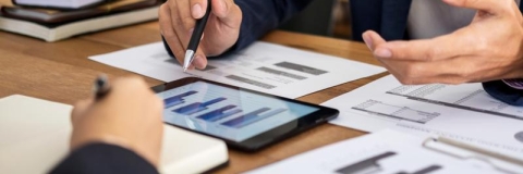 Financial graphs and charts being discussed