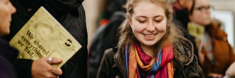 A prospective student and a parent smile at an invitation