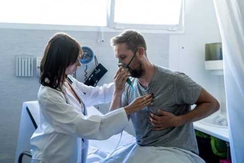 A patient with a respiratory condition being monitored by a medical professional