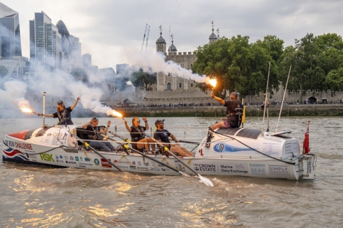 Rowing boat on The Thames setting off flares