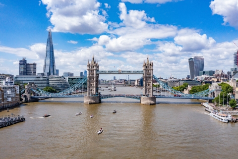 Three rowing boats passing under Tower Bridge, London