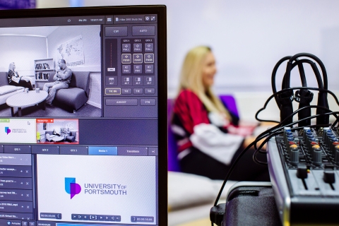 Computer screen and audio equipment monitoring an interview