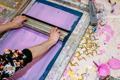 A person using a screen coating unit