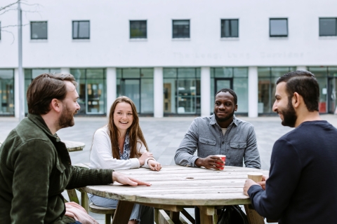 Four students sat around table talking and relaxing
NOT FOR THIRD PARTY - CONSENT