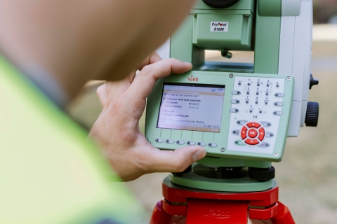 Student conducts measurements using landscape mapping device outside Technology Facilities