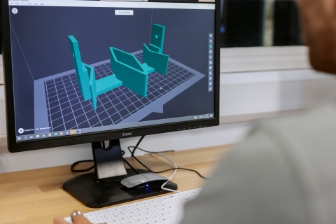 Staff member setting up 3D printer on display.
Technology Facilities Day One