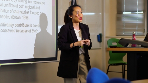 A student presenting in a lecture theatre