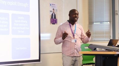 A student presenting his research in a lecture theatre