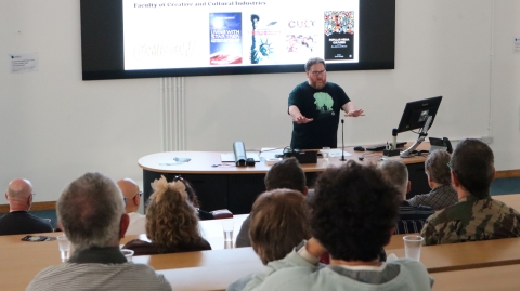 A lecturer giving a talk in a lecture theatre
