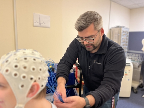 University of Portsmouth PhD student Benjamin Stocker setting up the EEG system on a participant