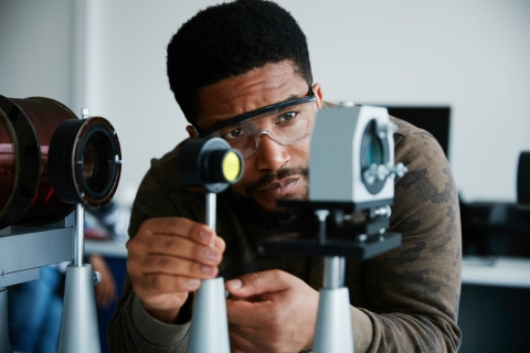 Male BAME scientist studying the Zeeman effect