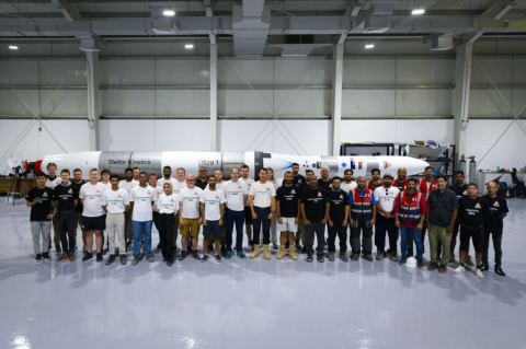 Group photo next to the rocket before launch