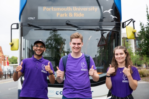 Three student ambassadors standing by Park and Ride bus - Open Day 2023