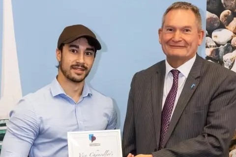 Headshot of Thierry Bridges smiling with vice chancellor 