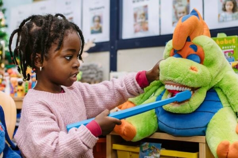 A child practicing brushing teeth