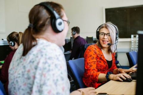 female student red shirt computer headset