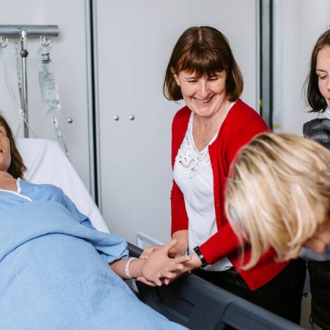 Nursing students training with simulated patient