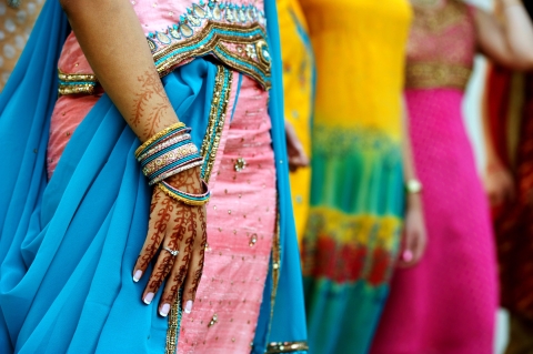 Henna design on person's hand in traditional Asian attire