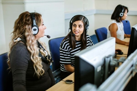 Students talking in language labs room at computers