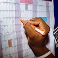 Person writing on calendar 