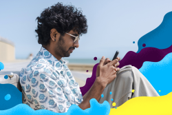 Man using his phone on the beach 