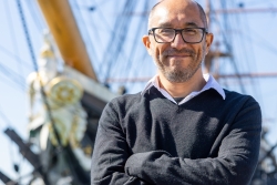 Carlos Ausejo in Portsmouth in front of HMS Warrior - a pioneering iron-hulled ship, launched in 1860, and powered by steam and sail