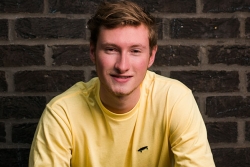 Clearing student crouching on a bench