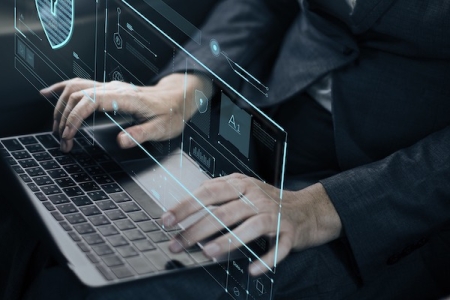 Hands on a laptop keyboard