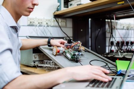 Student holding a robot