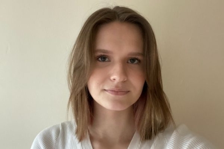 Katarzyna, a young female wearing white jumper with brown should length hair