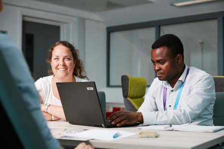 Male and female University of Portsmouth staff in business meeting