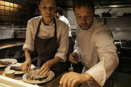 two chefs preparing a dish